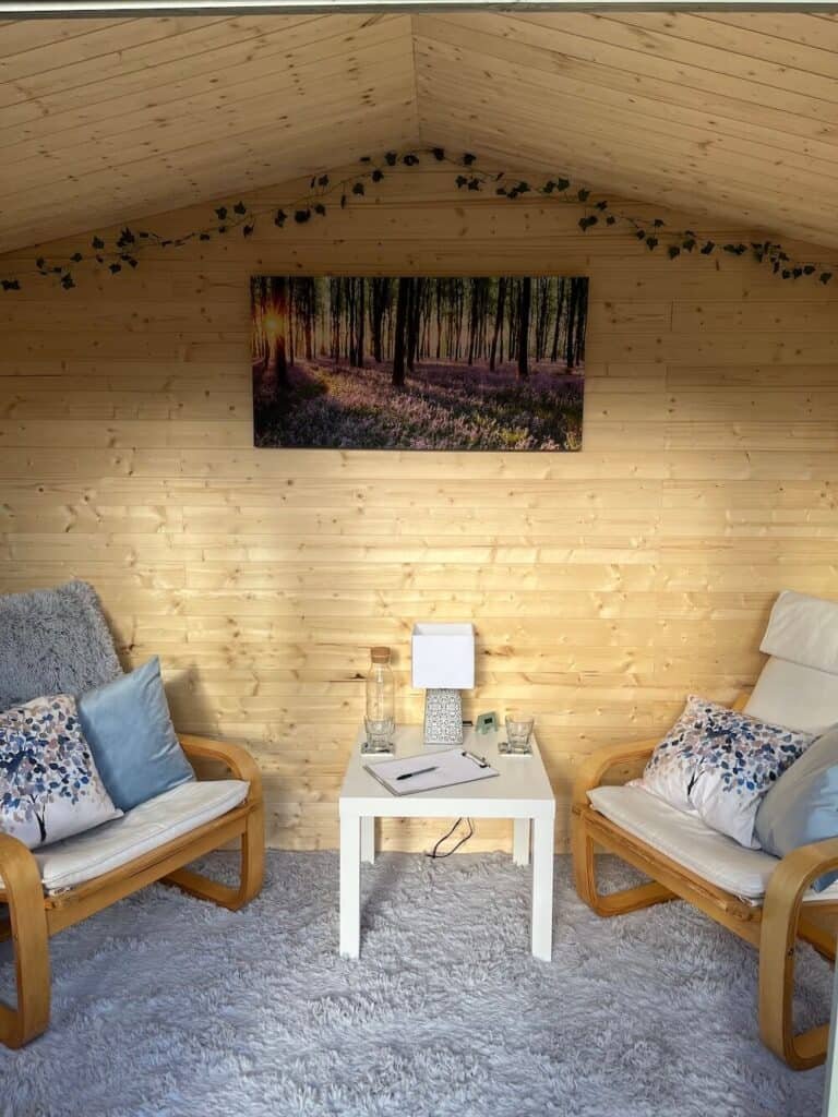 Interior of The Counselling Cabin, Ravenshead - wooden cosy cabin with picture of bluebells